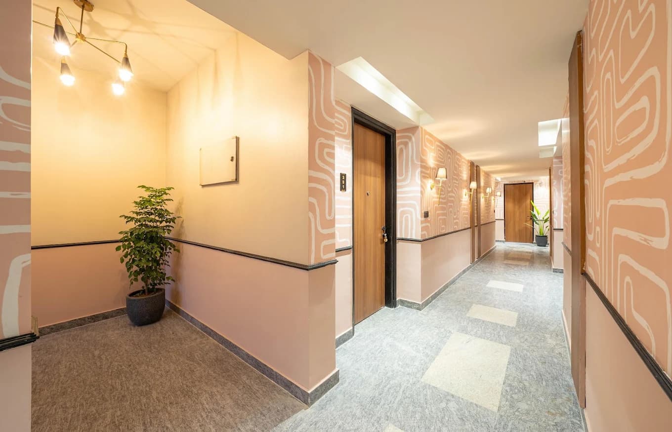 Patterned corridor with brass sconces